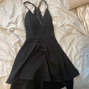 New with tags, never worn, size small black dress with cutout back